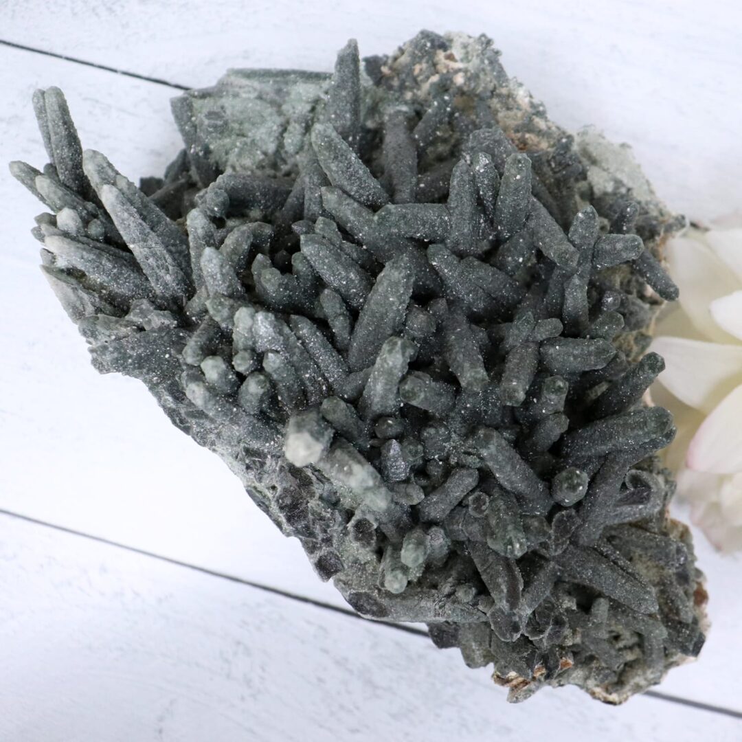 A cluster of black crystals on a white table.