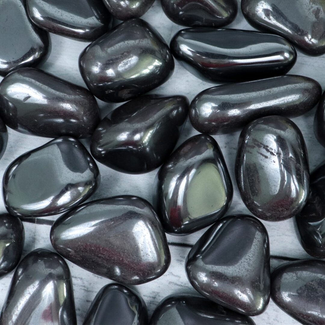 A pile of black pebbles on a metal surface.