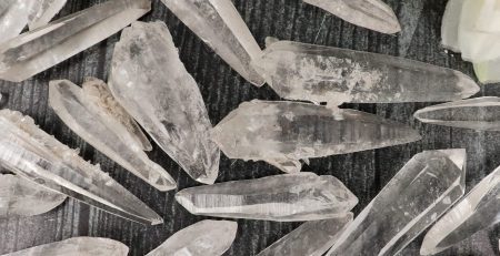 A bunch of crystal points on a table.