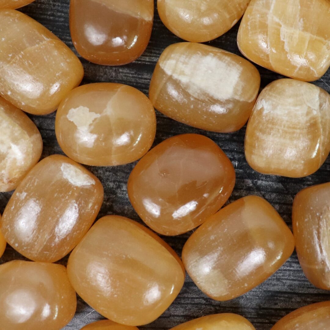 A group of yellow quartz cubes on a wooden surface.