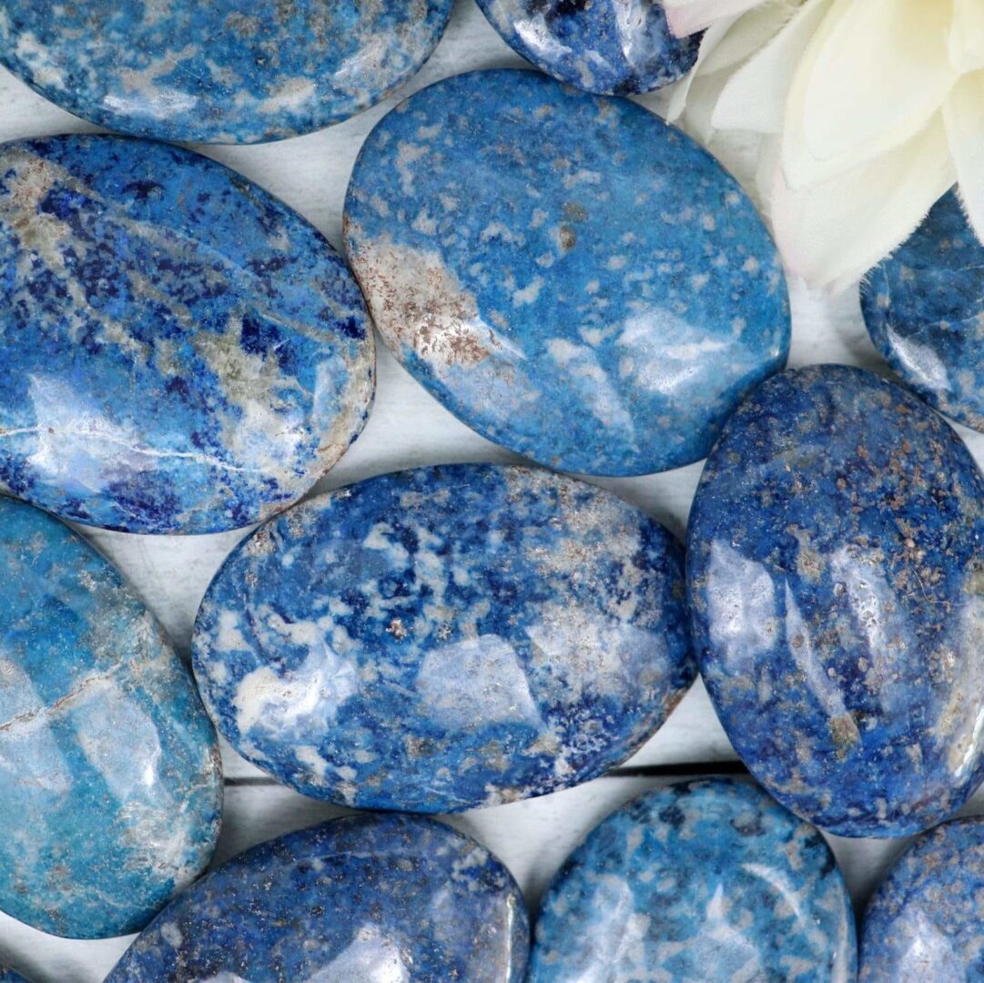 A bunch of blue stones with a flower in the middle.