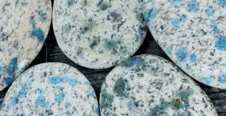 A group of stones with blue and black spots on them.