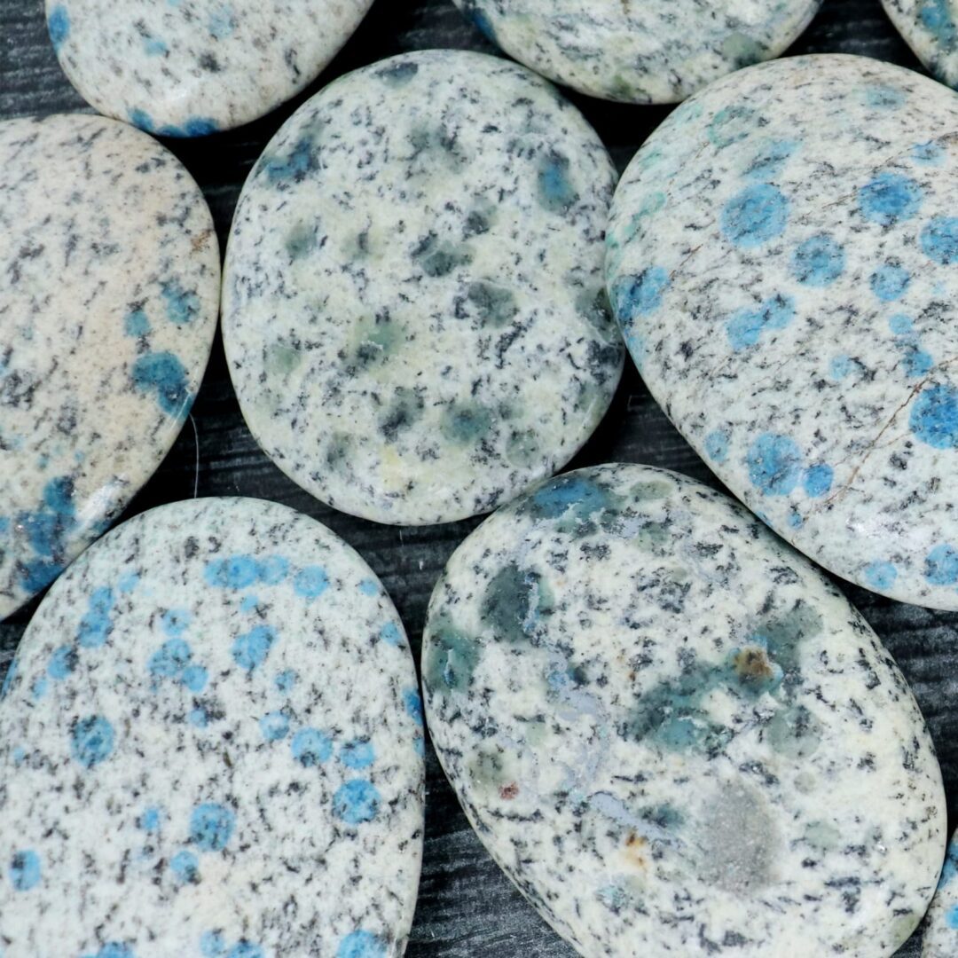 A group of stones with blue and black spots on them.