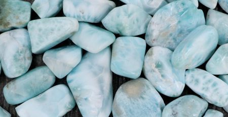 A pile of blue stones on a wooden surface.