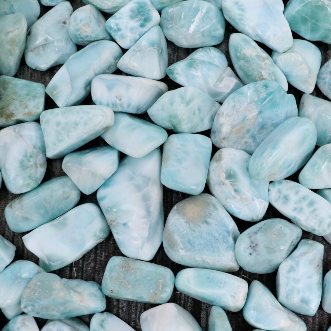 A pile of blue stones on a wooden surface.