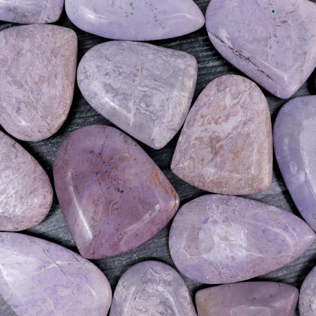 Purple amethyst stones on a wooden surface.