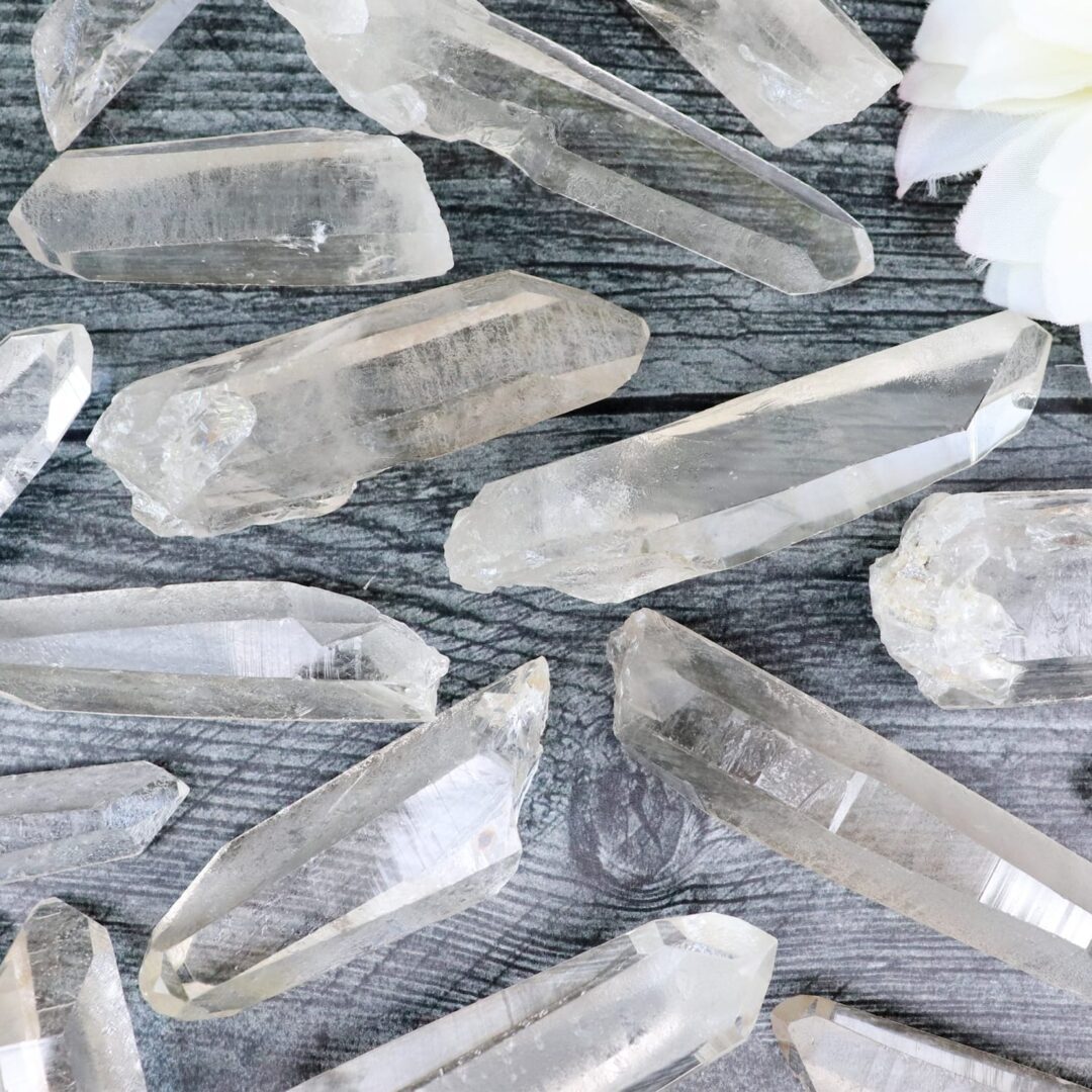 A bunch of crystal points on a wooden table.