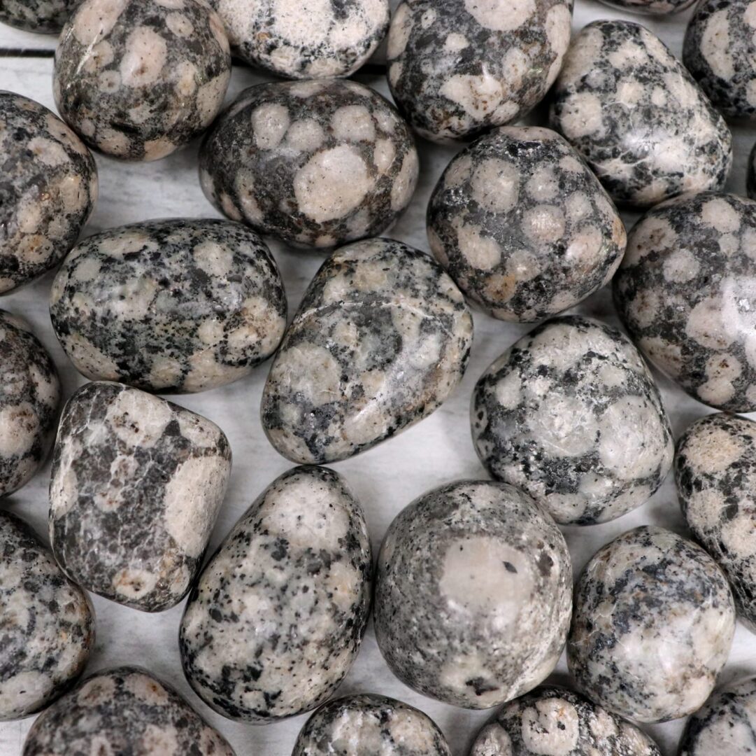 A pile of black and white stones on a white surface.