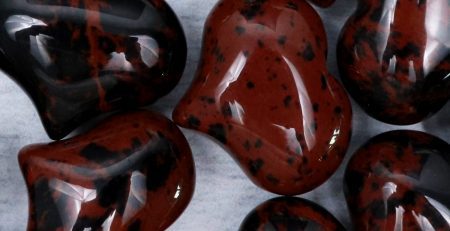 A group of red and black heart shaped beads.