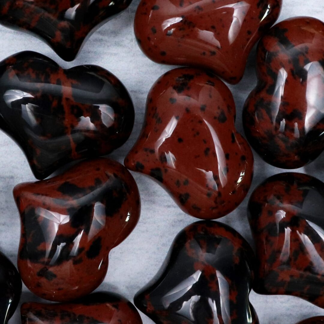 A group of red and black heart shaped beads.