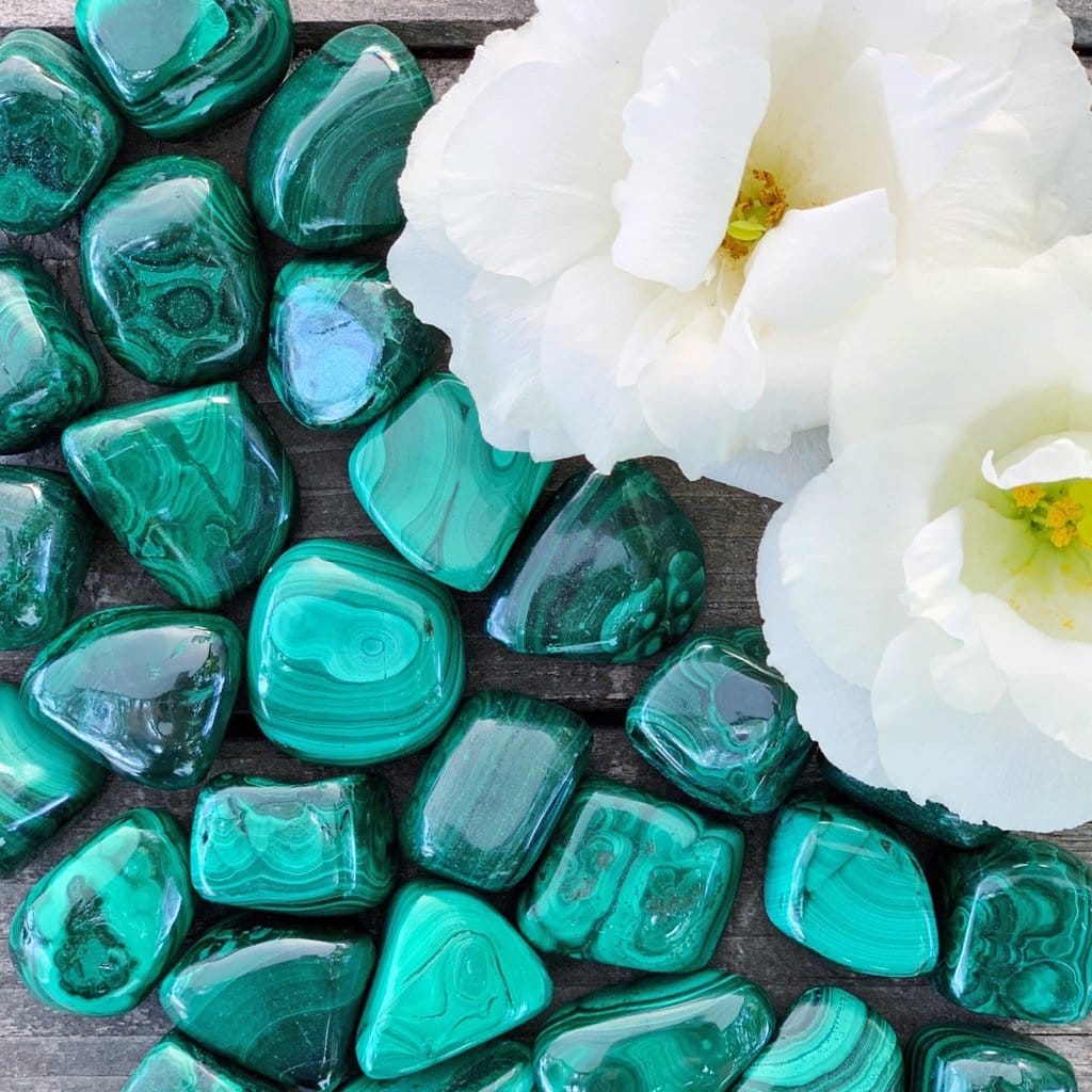 Emerald green malachite stones with white flowers.