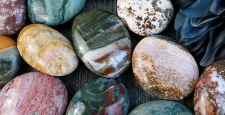 A group of colorful marble eggs arranged on a wooden table.