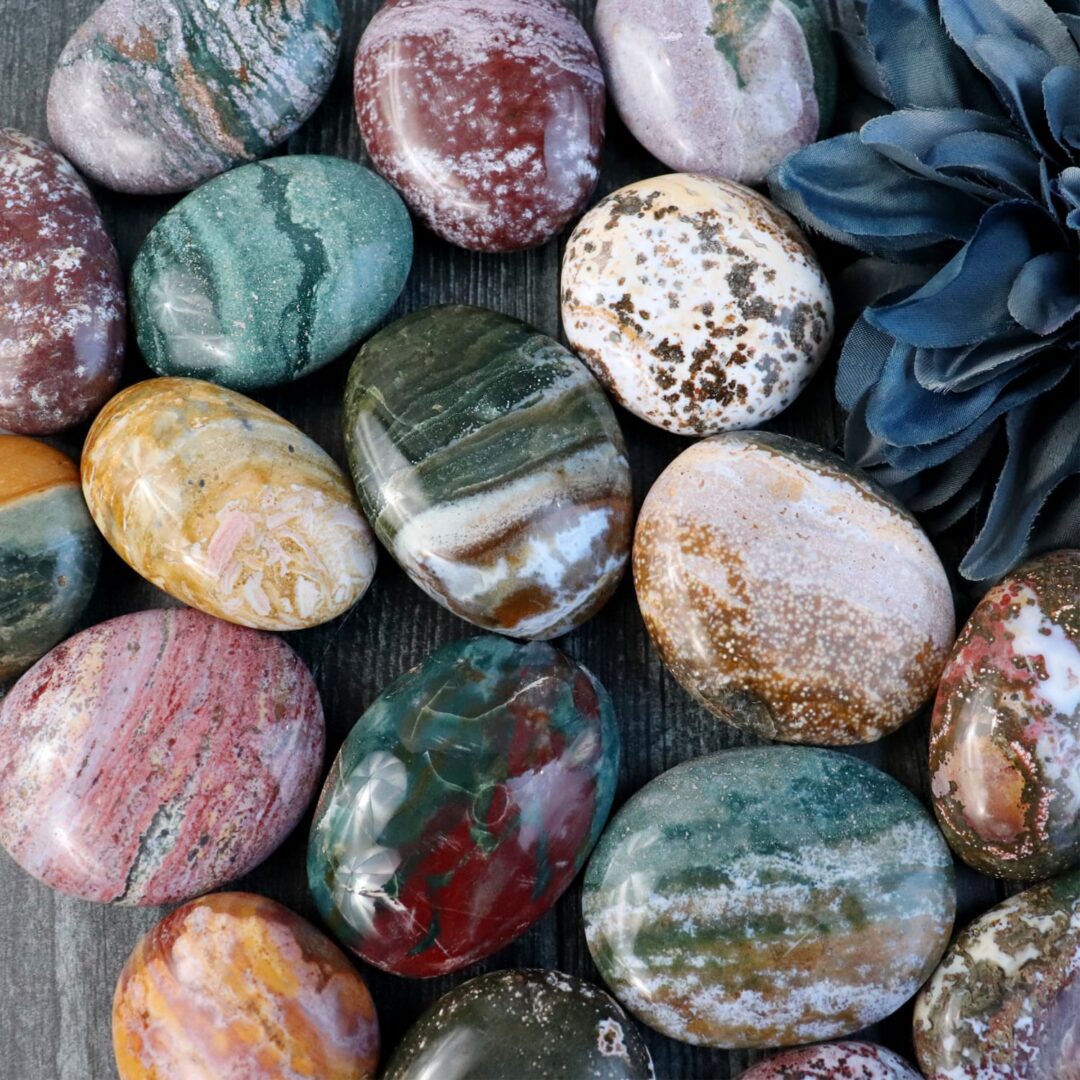 A group of colorful marble eggs arranged on a wooden table.