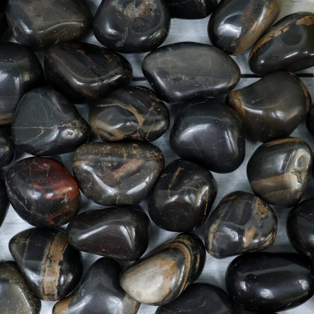 A pile of black and brown stones on a table.