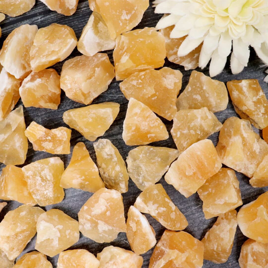 A pile of yellow crystals with a flower in the middle.