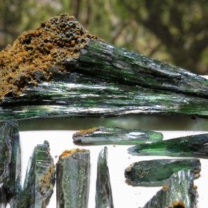 Green and brown crystal formations on white.