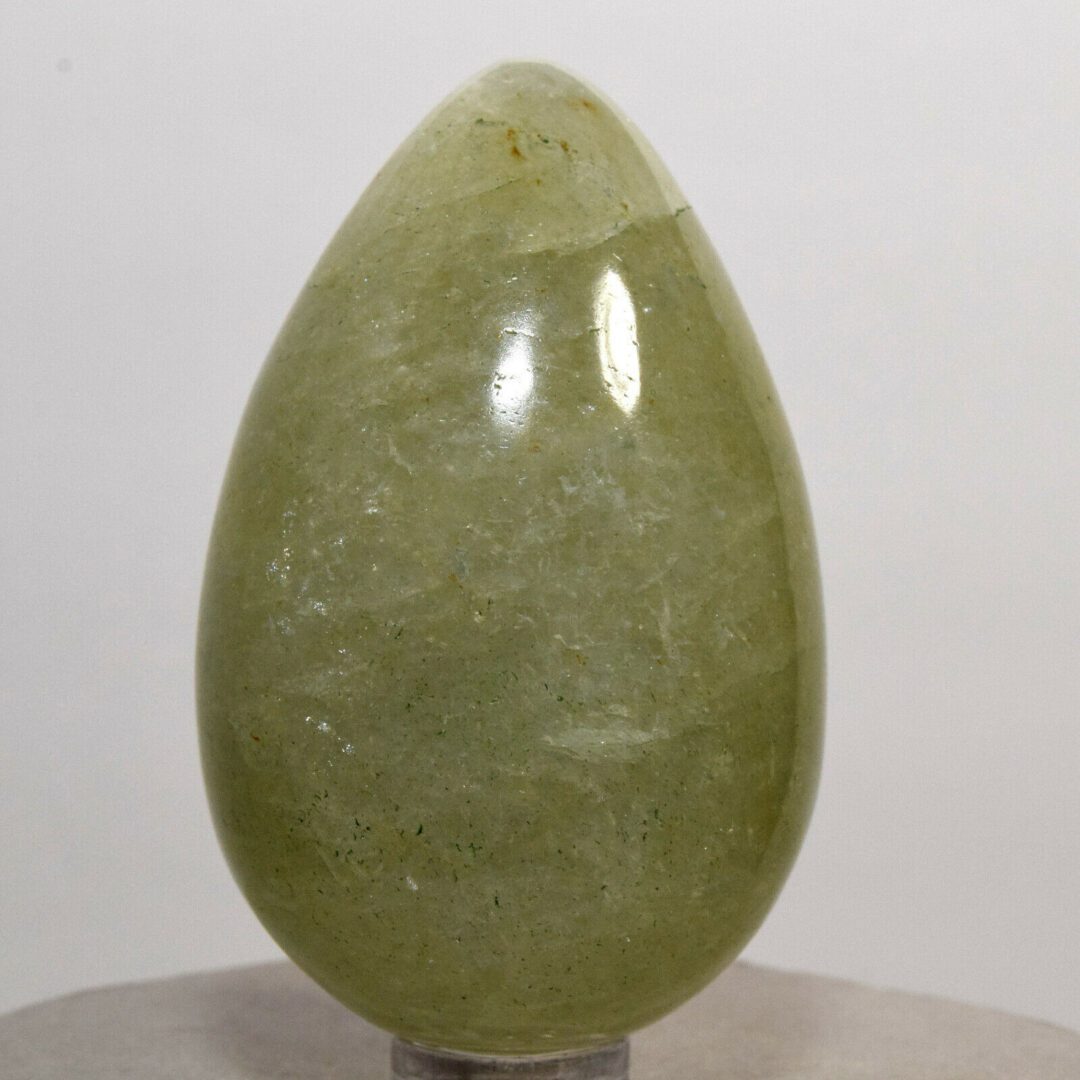 A green jade egg on a stand.