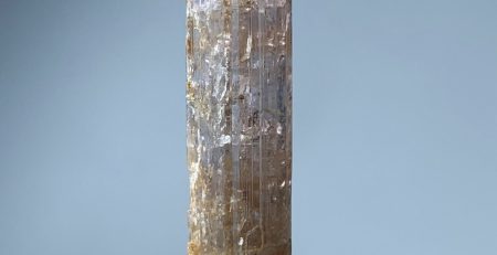 A piece of quartz sitting on top of a white piece of paper.