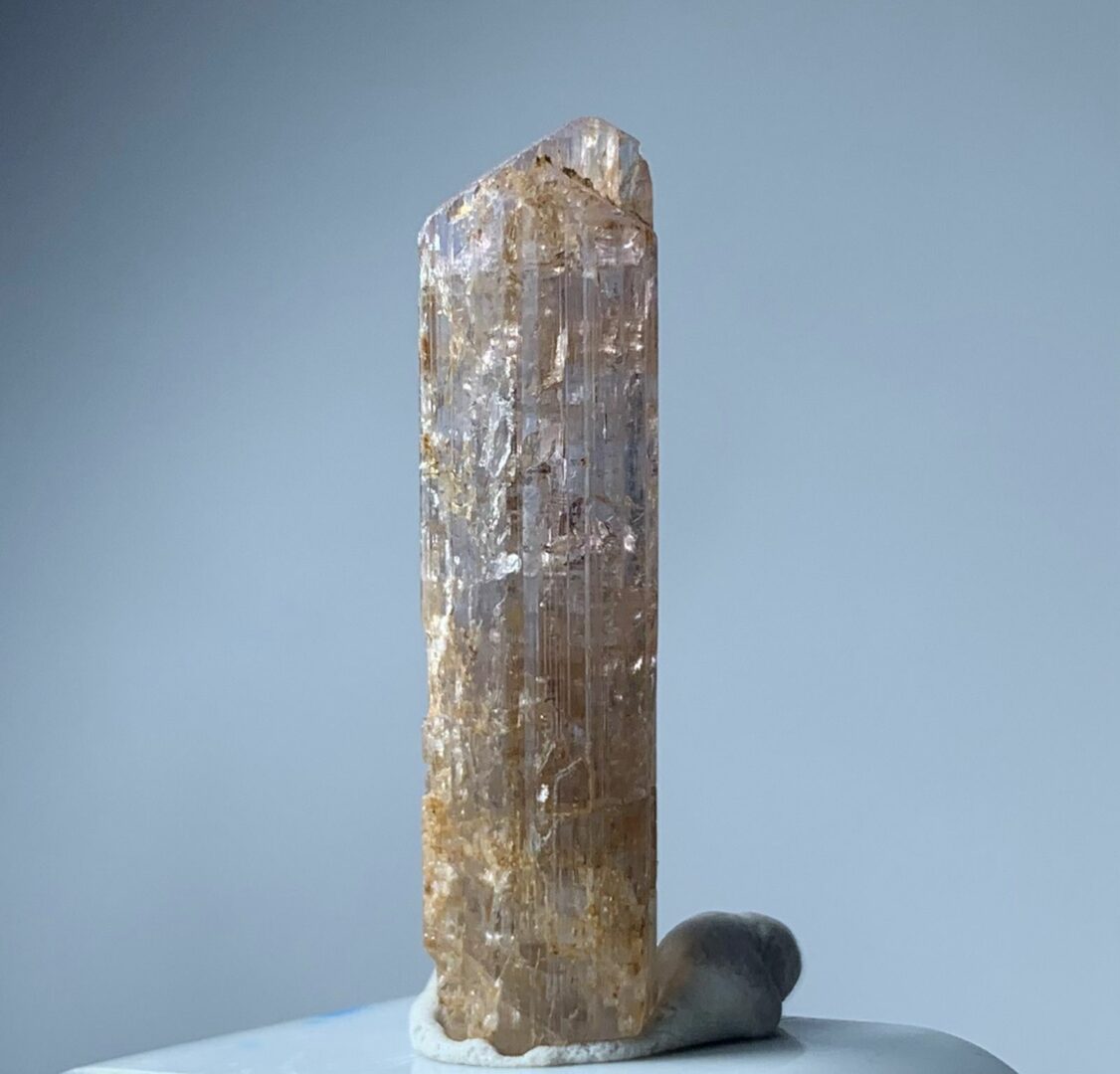 A piece of quartz sitting on top of a white piece of paper.