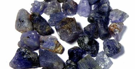 A bunch of blue and purple crystals on a white background.