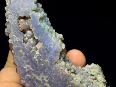A person holding a piece of blue agate.