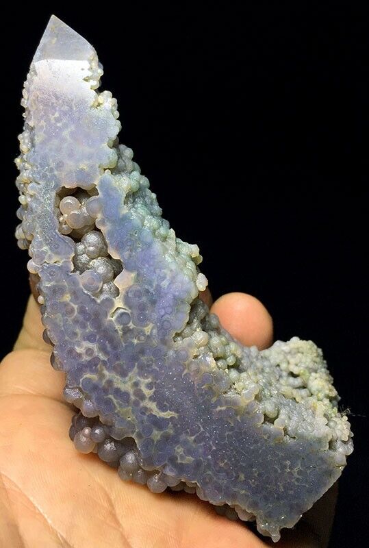 A person holding a piece of blue agate.