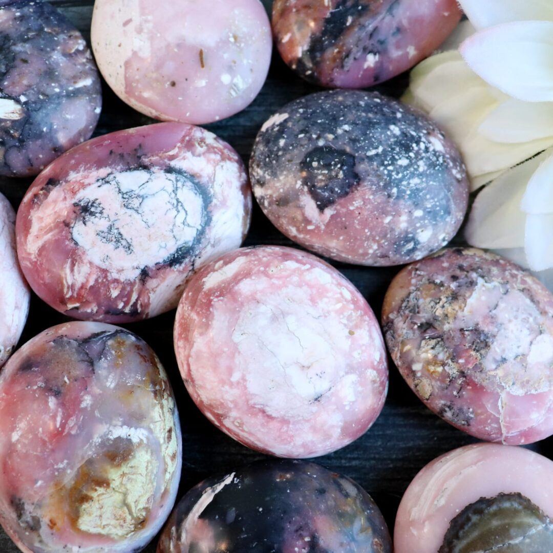 A bunch of pink and white marble eggs on a table.