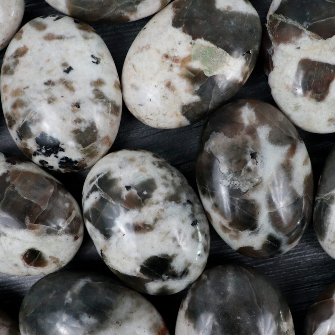 A group of black and white marble eggs on a table.