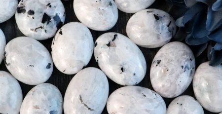 A bunch of white marble eggs with blue flowers.