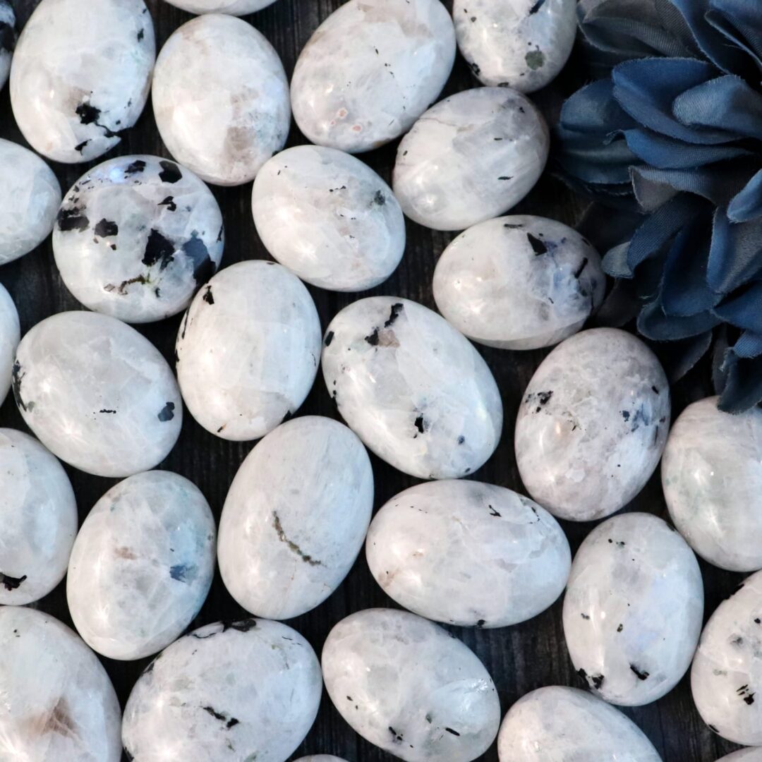 A bunch of white marble eggs with blue flowers.