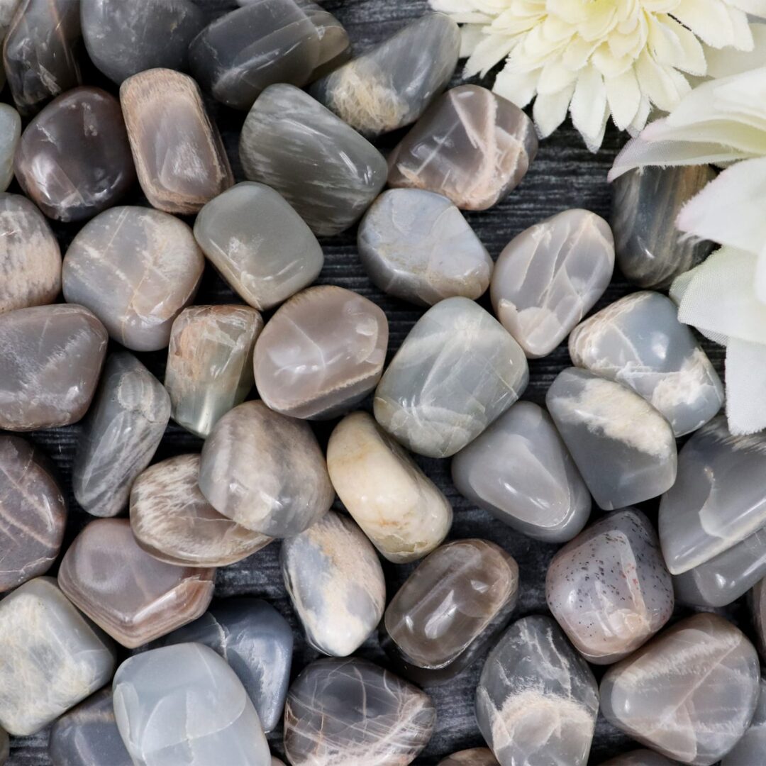 A pile of gray and white pebbles on a wooden table.