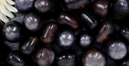 A bunch of black and brown stones on a table.