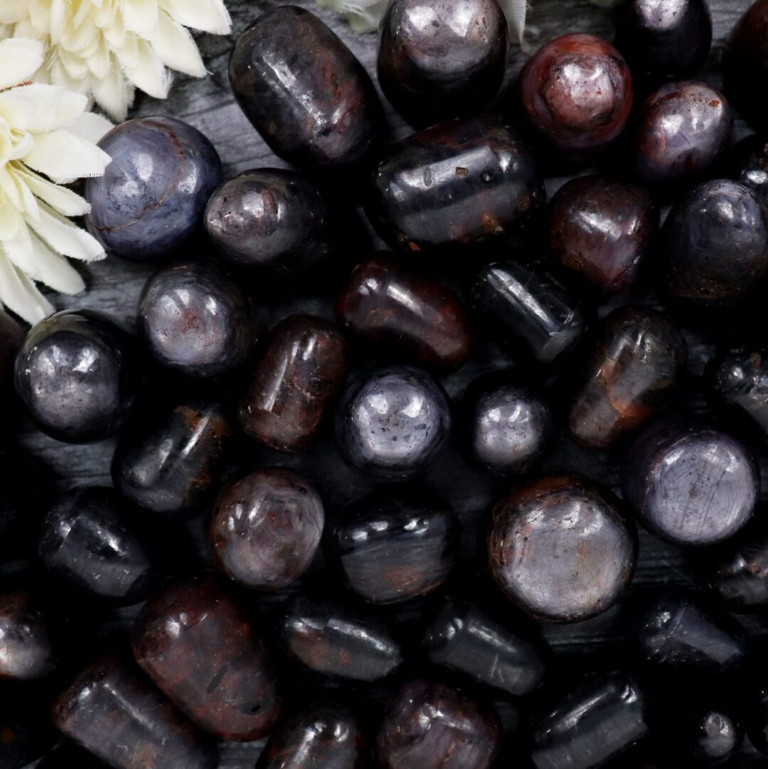 A bunch of black and brown stones on a table.