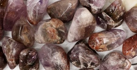 Purple amethyst crystals on a white table.