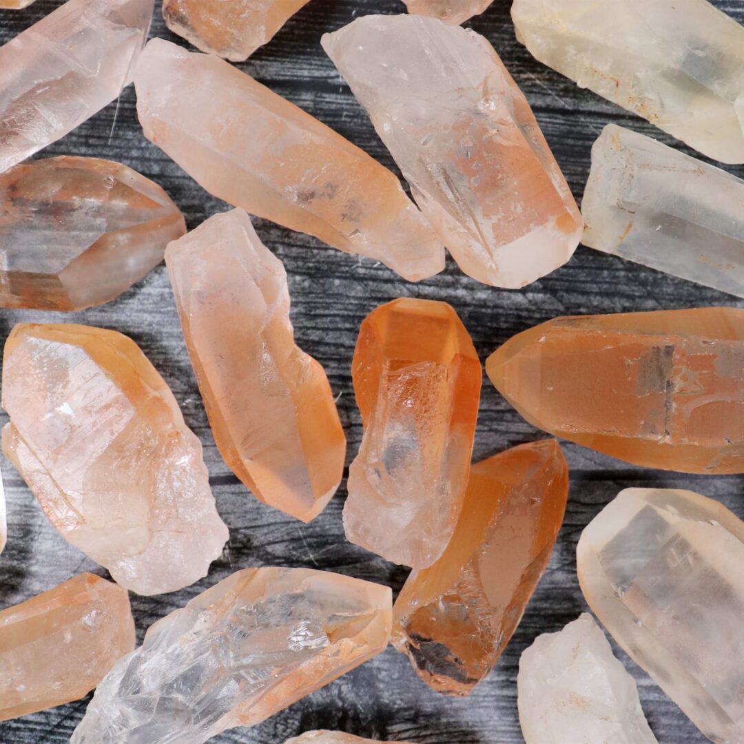 A pile of orange and yellow crystals on a wooden surface.