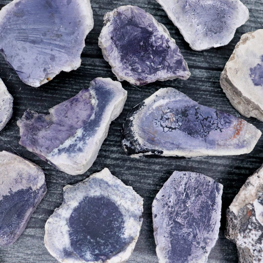 Purple amethyst pieces on a wooden surface.