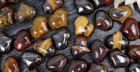 A bunch of tiger eye beads on a table.