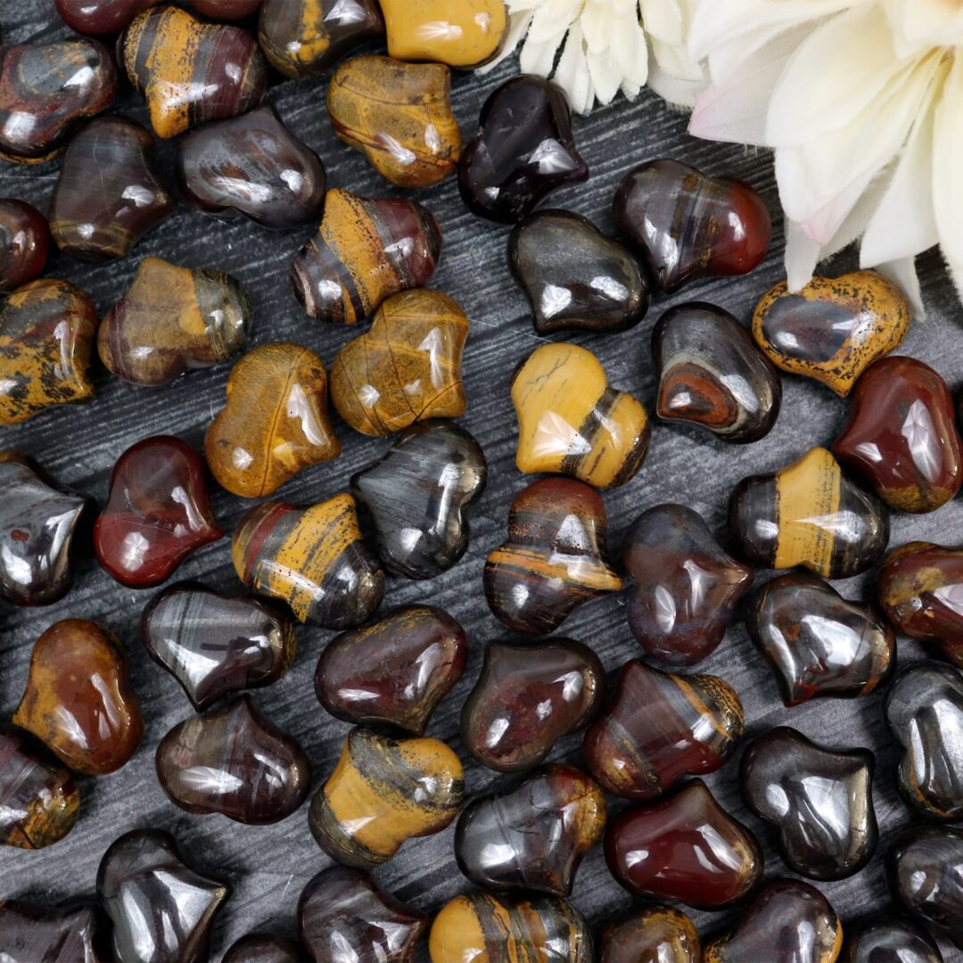 A bunch of tiger eye beads on a table.