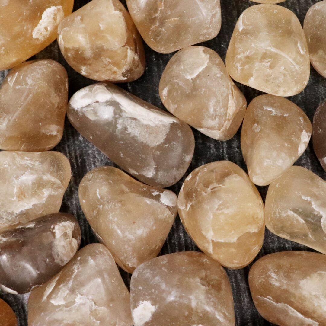 A pile of brown and white stones on a wooden surface.