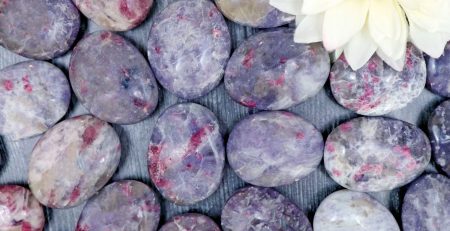 Purple amethyst pebbles with a flower in the middle.