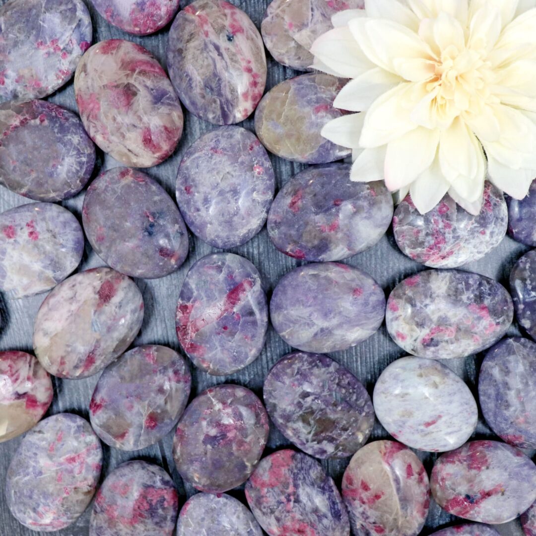 Purple amethyst pebbles with a flower in the middle.