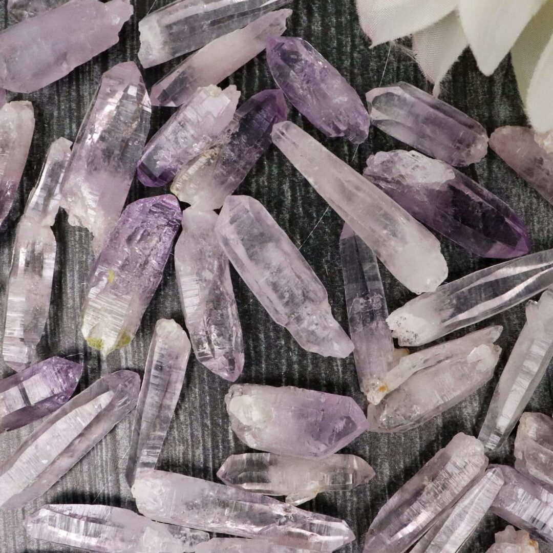 Amethyst crystals in a pile on a table.