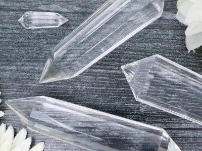 A group of clear crystal points laying on a table.