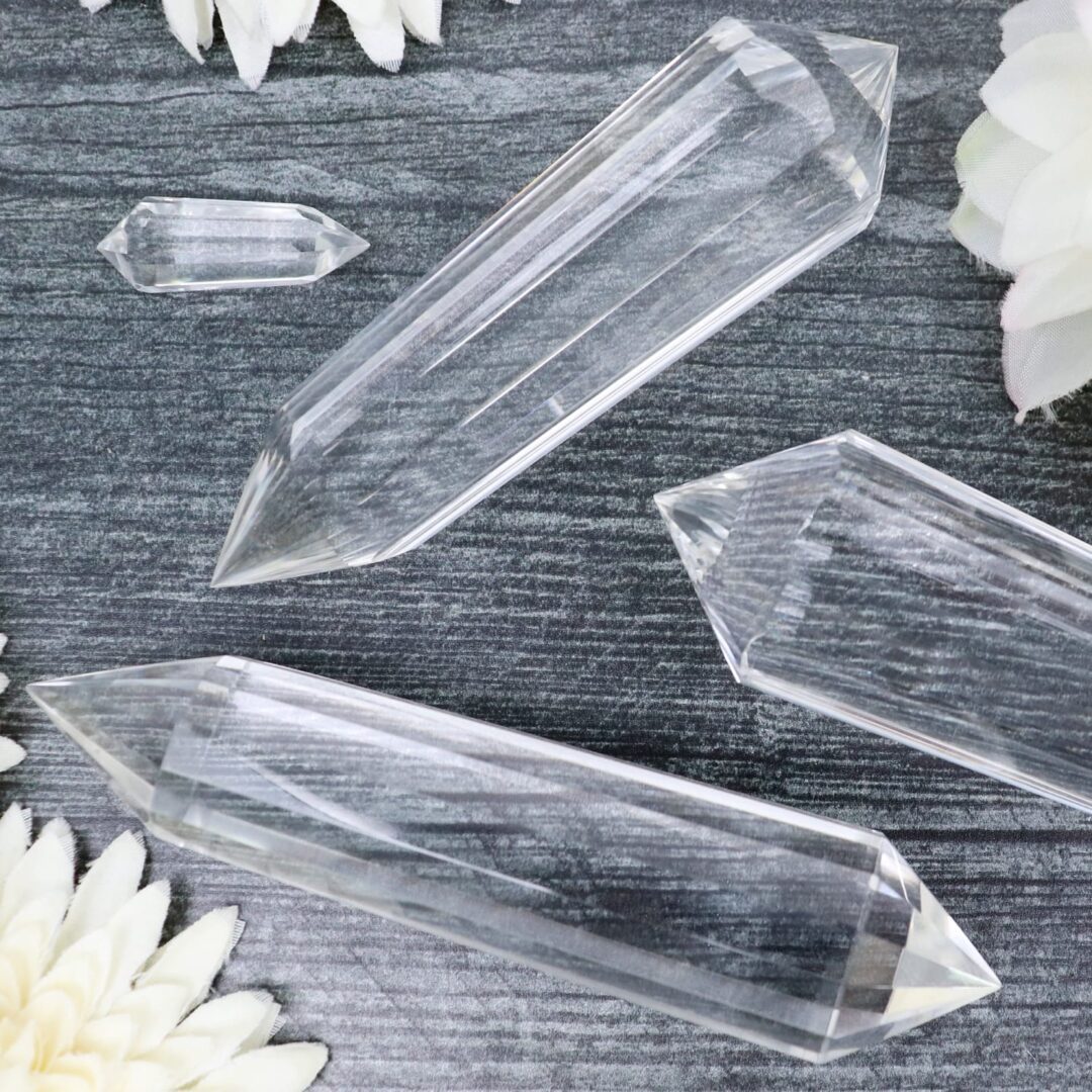 A group of clear crystal points laying on a table.