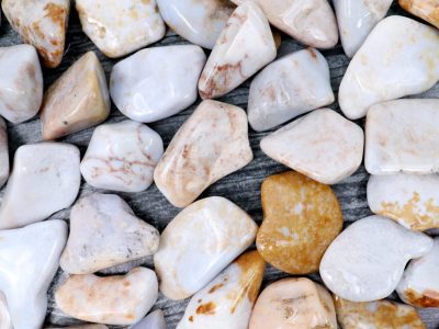 A pile of white and brown pebbles on a wooden surface.