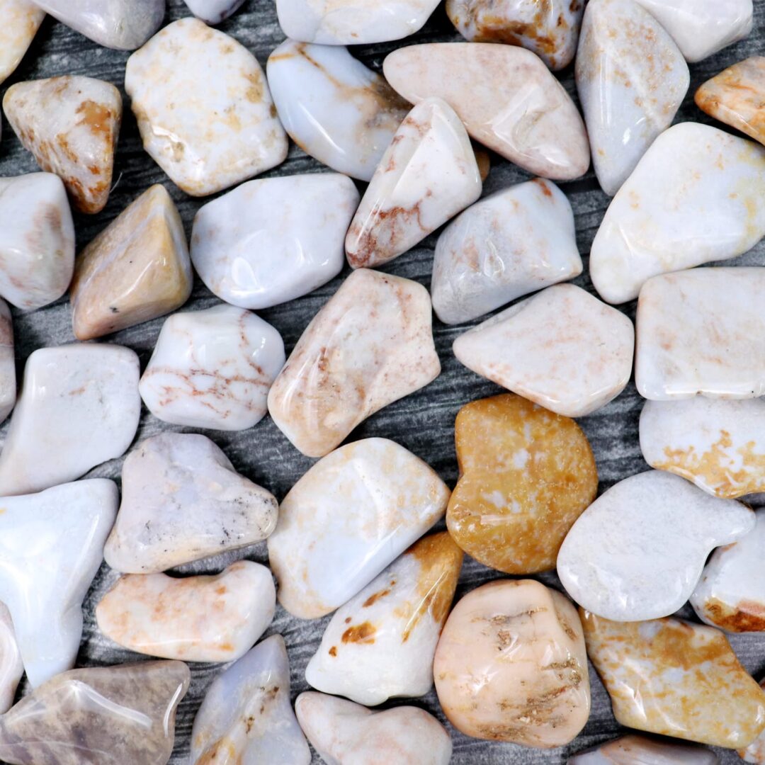 A pile of white and brown pebbles on a wooden surface.