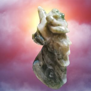 Carved stone unicorn figurine against clouds.