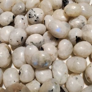 Close-up of white, smooth moonstone pebbles.