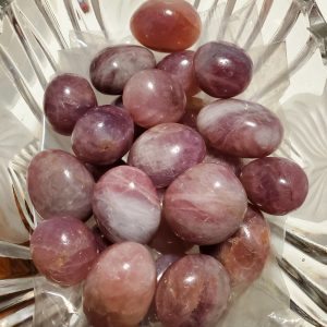 Collection of pink and white tumbled stones.