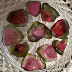 Watermelon tourmaline gemstones in bowl.